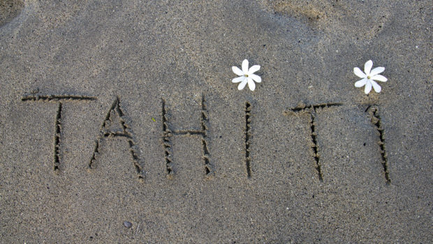 tahiti-written-on-the-sand-with-two-white-flowers-117995002.jpg